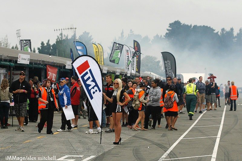 Pit lane crowd gathered behind the BNT flag