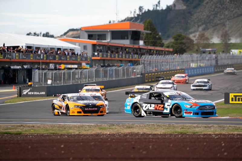 TA2 NZ Mustang leading a touring car into a corner at Taupo