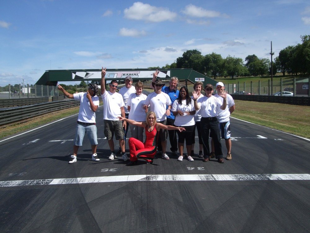 Track experience group on the start line under the GT Radial bridge